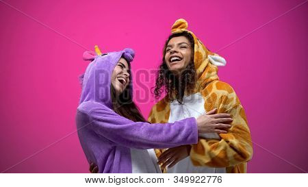 Funny Young Women Wearing Unicorn And Giraffe Pajamas, Laughing, Entertainment