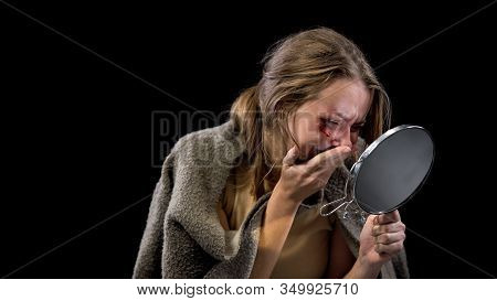 Crying Young Female Looking At Wound Reflection In Small Mirror, Domestic Abuse