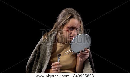 Bruised Woman Holding Make-up Brush, Trying To Mask Wound On Cheek, Mistreatment