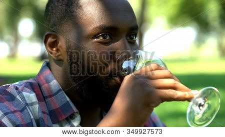 Black Male Drinking Wine, Gathering With Friends In Park, Relax Time On Picnic