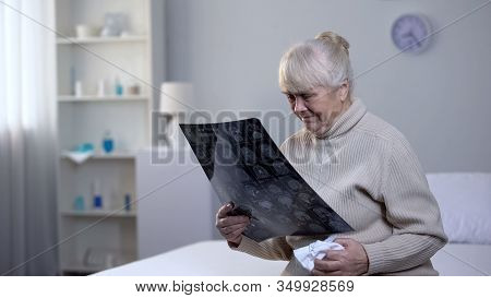 Crying Old Lady Looking At Brain X-ray In Hospital, Incurable Disease, Health