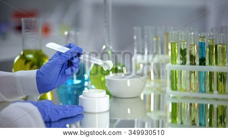 Biochemist Taking Creme Sample From Tube, Organic Beauty Production, Dermatology