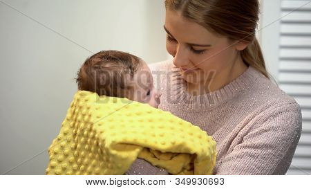Young Mother Holding Adorable Baby In Arms, Artificial Feeding, Newborn Care