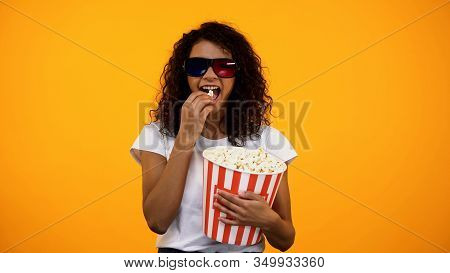Afro-american Female In 3d Glasses Eating Popcorn And Watching Comedy Show