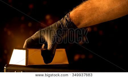 Hand In Glove Putting Gold Bullion, Evaluation Of Precious Metals, Pawnshop