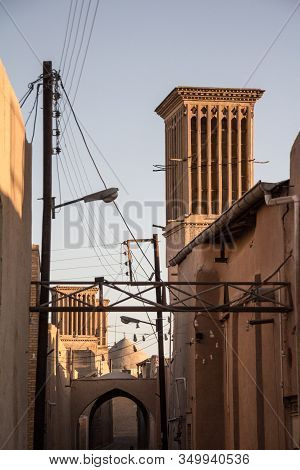 Typical Windtower Made Of Clay Taken In The Streets Of Yazd, Iran, Surrounded By Power Electrical Li