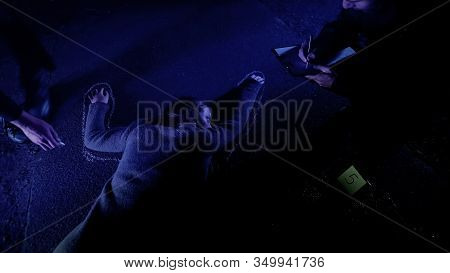 Policeman Fixing Position Of Corpse With Chalk, Crime Scene Investigation