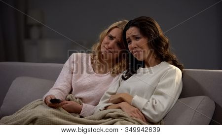 Emotional Beautiful Girls Watching Melodrama And Crying, Sitting On Sofa At Home