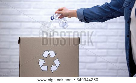 Person Throwing Plastic Bottles Into Trash Bin, Sorting Non-degradable Waste