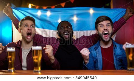 Emotional Black And Caucasian Men Cheering For Argentinian Football Team, Bar