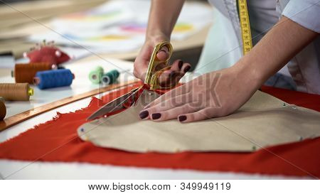 Student Clumsily Treating With Scissors And Cloth Trying To Cut Out Pattern
