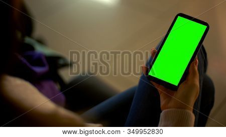 Young Lady Holding Smartphone With Green Screen, Place For Advertisement, Device