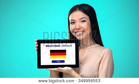 Female Holding Tablet With Learn German Application, Ready To Start Course