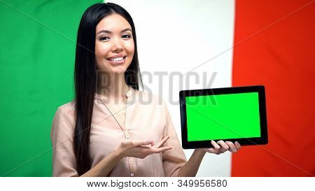 Girl Holding Tablet With Green Screen, Italian Flag On Background, Migration
