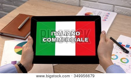 Business Italian Application Against Flag On Tablet In Female Hands, Tutorial