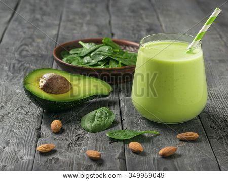 A Drink Of Avocado, Spinach And Almond Milk On A Dark Wooden Table. Fitness Product. Dietary Sports 