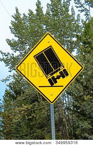 A Truckers Warning Sign About Tipping Hazards