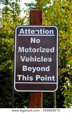 An Attention No Motorized Vehciles Beyond This Point Sign