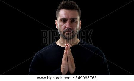 Crying Male Joining Hands And Praying On Black Background, Sins Atonement, Faith