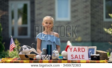 Young Business Lady Selling Old Toys On Yard Sale, Earning Extra Pocket Money