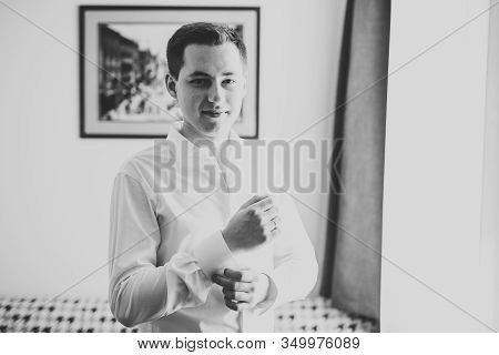 Grooms Morning Preparation. Handsome Man Getting Dressed And Preparing For The Wedding