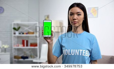 Charity Fund Worker Showing Smartphone Green Screen, Volunteering App, Help