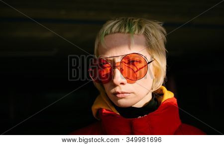 blond lesbian woman with red singlasses