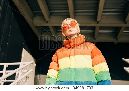 blond lesbian woman with red singlasses 
