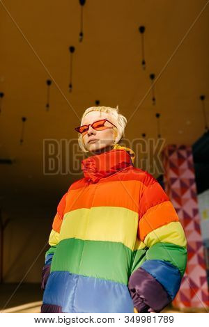 blond lesbian woman with red singlasses 