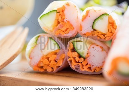 Fresh Vegetable And Crab Stricks Salad Roll Wrap With Noodle On Wood Plate On Tablecloths On White W