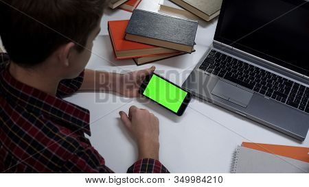 Teenager With Green Screen Smartphone Hands Watching Online Video, Application