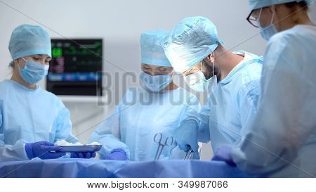 Team Of Professional Surgeons On Hospital Operation, Saving Patient Life