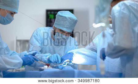 Surgeon Team Working In Operation Room, Performing Cardiothoracic Surgery
