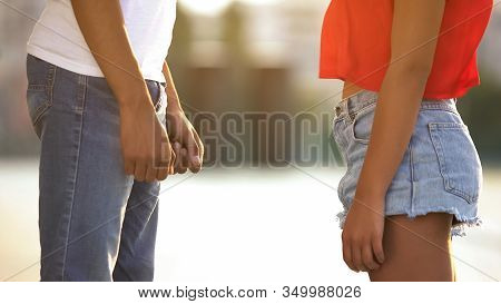 Shy Teenagers Standing Front Each Other, Hesitating To Make First Step To Love