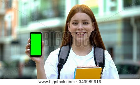 Happy Female Student Showing Green Screen Phone, Online University Schedule, App