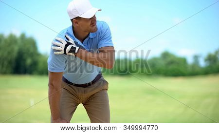 Young Male Golf Player Suffering Terrible Shoulder Spasm After Shot, Trauma