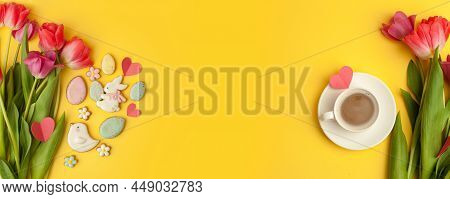 Easter Gingerbread Cookies, Spring Flowers, Cup Of Coffee On Yellow Background. Cozy Home Easter Gre