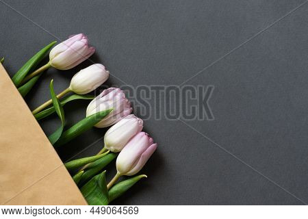 Spring Bouquet Of Pink Tulips In Beige Paper Bag On Gray Paper Background