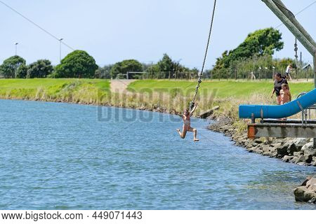 Opotiki New Zealand - January 30 2022; Young People Jumping Into Waioeka River Enjoying Summer Fun