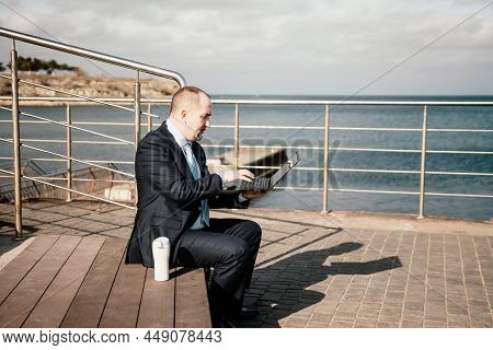 Confident Middle Age Businessman Working Remotely Online, Typing On A Laptop Keyboard While Sitting 