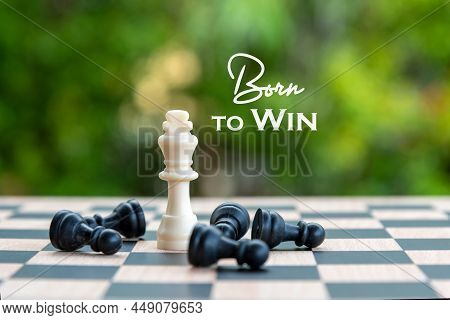 Inspirational Motivational Quote - Born To Win. With King And Black Pawn Chess Pieces On A Chessboar