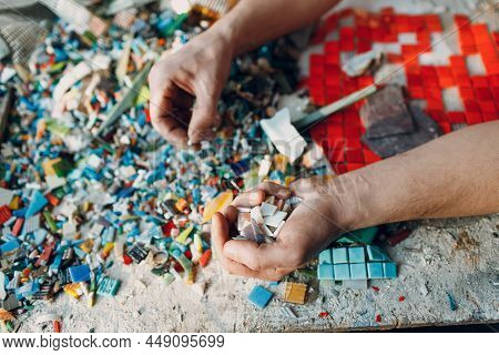 Man Mosaics Master Chooses Select Smalt Glass Pieces For Mosaic Panel. Male Mosaicist At Work