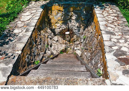 Spring With Pouring Water . Place For Drinking Water In Village