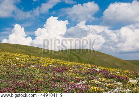 Spring Season In The Umbria Mountains With Blue Sky And Clouds
