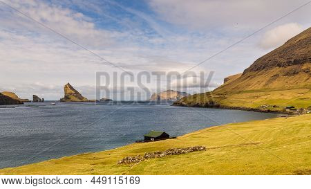View Of A Small Wooden House On The Coast Of Vagar. Bour, Faroe Islands.