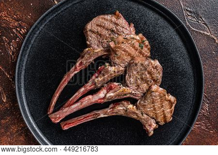 Bbq Grilled Lamb Chops Steaks In A Plate. Dark Background. Top View