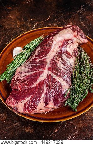 Raw Hanging Tender Or Ongle Beef Meat Steak On Rustic Plate With Herbs. Dark Background. Top View