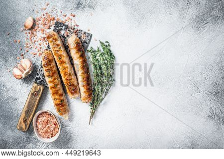 Grilled Bockwurst And Bratwurst Meat Sausages On A Cleaver. White Background. Top View. Copy Space