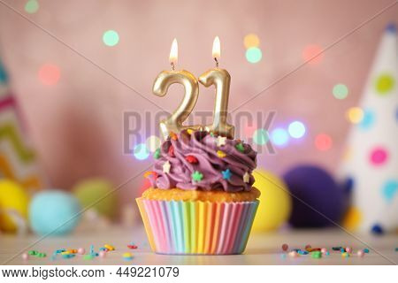 21th Birthday. Delicious Cupcake With Number Shaped Candles For Coming Of Age Party On White Table