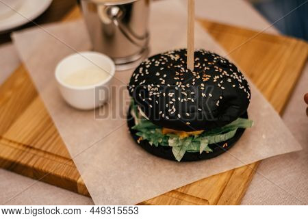 Big Tasty Delicious Black Sesame Benne Ham Burger With Stick, Green, Lettuce Near Garlicky White Sau